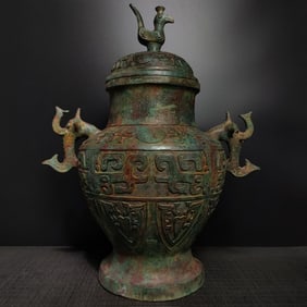 A Shang and Zhou bronze elephant trunk standing bird round jar