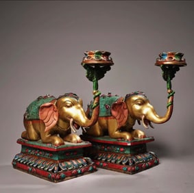 A pair of gemstone-encrusted gilded elephant oil lamps