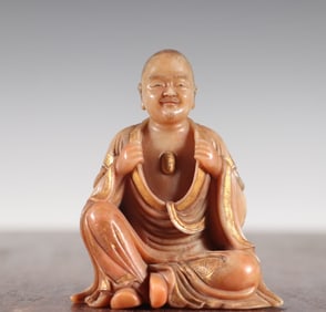 A statue of a Qing Dynasty Shoushan stone painted with gold painted Arhat