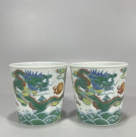 A pair of Qing Dynasty Yongzheng year Doucai Shuanglong seawater pattern straight cups