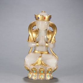 A seated statue of Guanyin in pure gold with Hetian jade bag