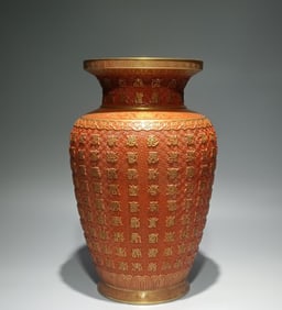 A Qing Dynasty Qianlong year alum red gold-painted carved Wanshou statue