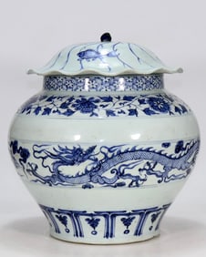 A Yuan blue and white double dragon chasing lotus leaf lid jar