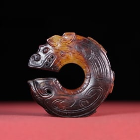 A Han Dynasty white jade dragon pendant