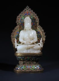 A statue of Guanyin in pure silver gilt in the Qing Dynasty inlaid with white jade