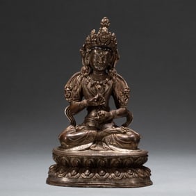 A Qing Dynasty copper-gilt platinum Buddha statue