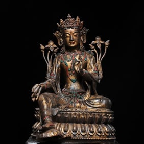A bronze gold green Tara statue