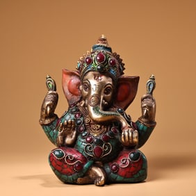 A statue of the God of Wealth with a gold-painted elephant trunk inlaid with gemstones
