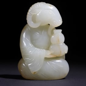 A Qing Dynasty Hetian jade sheep head holding a bottle ornament