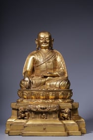 A seated statue of Guru Marpa in copper gilt from the Qing Dynasty