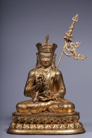 A seated statue of a bronze gilt peanut in the Qing Dynasty