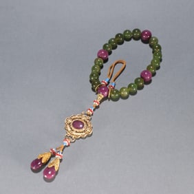 A piece of Qing Dynasty tourmaline held by eighteen sons
