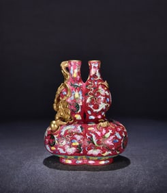 A Qing Qianlong red ground rolled road pattern Flag Lotus embossed gilt gourd bottle