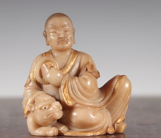 A Qing Dynasty longevity stone gold-painted Fuhu Arhat statue