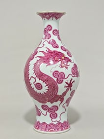 A Qing Dynasty Qianlong year enamel carmine red dragon and phoenix olive vase