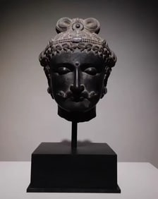 A rock carved head of a Khandra slice
