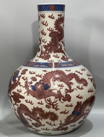 A clear blue and white glazed red dragon pattern celestial ball vase