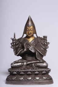 A seated statue of Tsongkhapa in copper-gilt silver clay with gold face