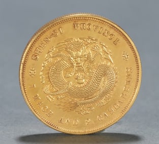 A Qing Dynasty silver-gilt vault flat seven qian and two cent coins