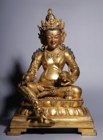 A seated statue of the God of Wealth in bronze gilt in the Qing Dynasty