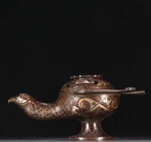 A bronze gold and silver bird incense burner