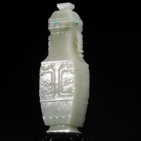 A Qing Dynasty green and white jade full of ancient pattern square bottle