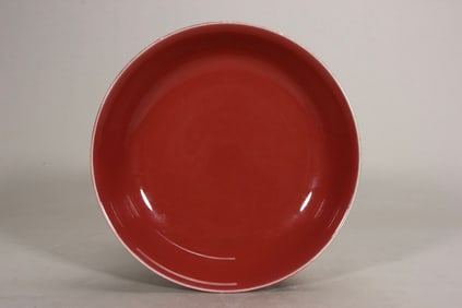 A Qing Dynasty Qianlong Ji red glazed plate