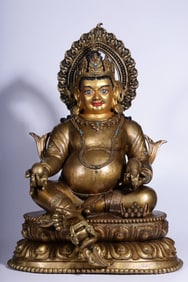 A seated statue of the God of Wealth in copper clay and gold in the Qing Dynasty