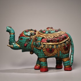 A painted elephant with gemstones and gilded on it