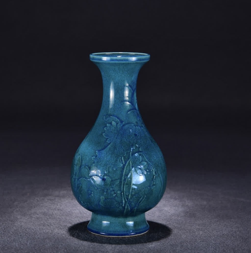 A Qing Qianlong peacock blue glaze carved lotus fun picture bottle (1 of 9)