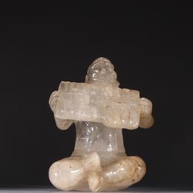 A statue of a crystal Hu man playing music