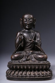 A seated statue of a bronze Arhat in the Qing Dynasty