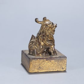 A copper gilt beast button seal