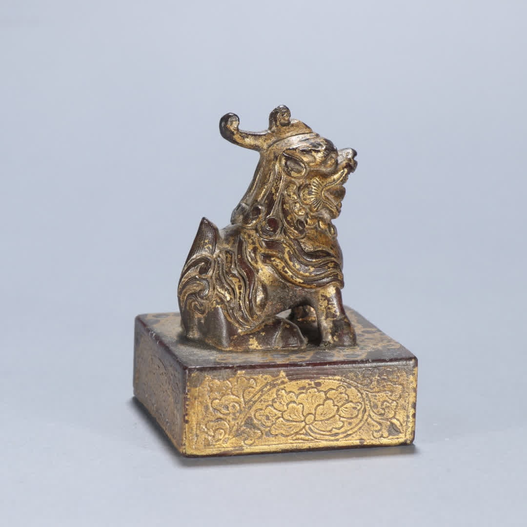 A copper gilt beast button seal (1 of 9)