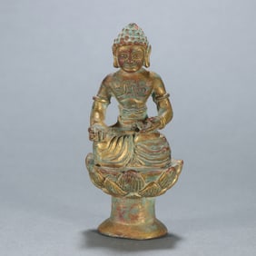 A copper gilt Buddha ornament