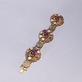 A silver-gilt multi-treasure bracelet