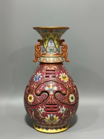 A carmine red pastel rolled road entwined lotus carved bottle made in the Qianlong period of the