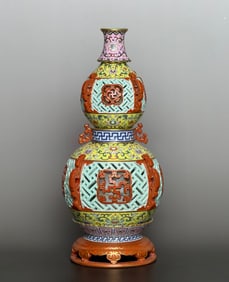 A Qing Qianlong entwined lotus swastika hollow carving turning center gourd bottle