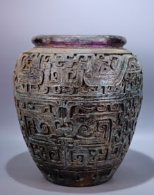 A large jar full of purple glass carvings