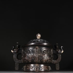A Qing Dynasty rosewood imitation bronze gluttonous pattern incense burner