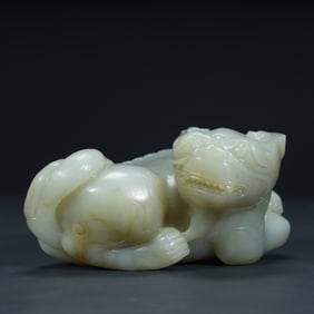 Qing Dynasty white jade round carving to ward off evil beasts