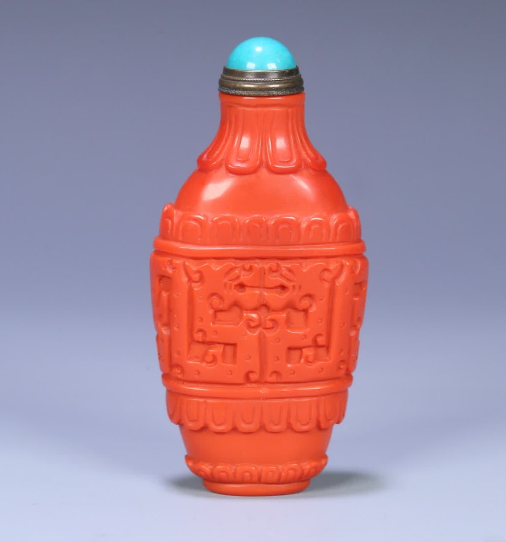 A Qing Dynasty coral-colored glazed snuff bottle (1 of 9)