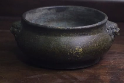 A Qing Dynasty qin and book companion lion's ear copper furnace