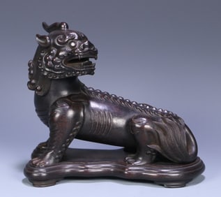 A Qing Dynasty rosewood unicorn ornament