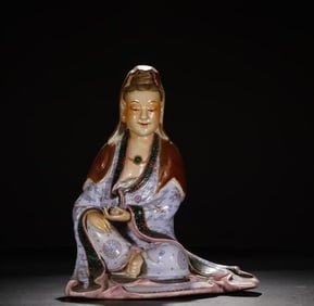 A sculptural porcelain seated statue of Guanyin