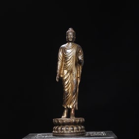 A statue of Shakyamuni Buddha in copper clay and gold