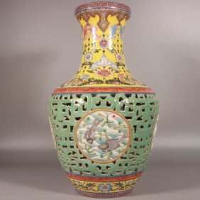 A Qing Qianlong pastel yellow bean celadon hollow carved fish bottle