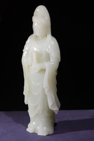A Qing Dynasty green and white jade carving statue of Guanyin holding a lotus