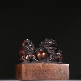 A Qing Dynasty agarwood lioness button seal