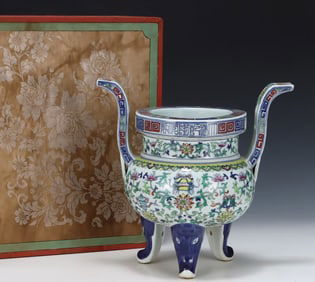 A three-legged incense burner with a Qing Dynasty Qianlong Doucai entwined floral pattern